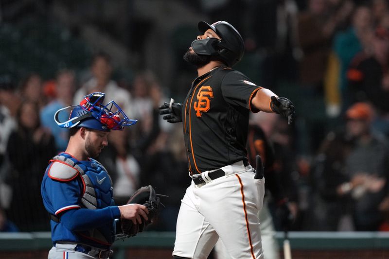 Aug 12, 2023; San Francisco, California, USA; San Francisco Giants right fielder Heliot Ramos (right) gestures after hitting a home run as Texas Rangers catcher Mitch Garver (18) kneels at home plate during the ninth inning at Oracle Park. Mandatory Credit: Darren Yamashita-USA TODAY Sports