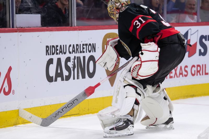 Feb 22, 2024; Ottawa, Ontario, CAN; Ottawa Senators goalie Anton Forsberg (31) recovers his stick which got wedged in the boards during the second period against the Dallas Stars at the Canadian Tire Centre. Mandatory Credit: Marc DesRosiers-USA TODAY Sports