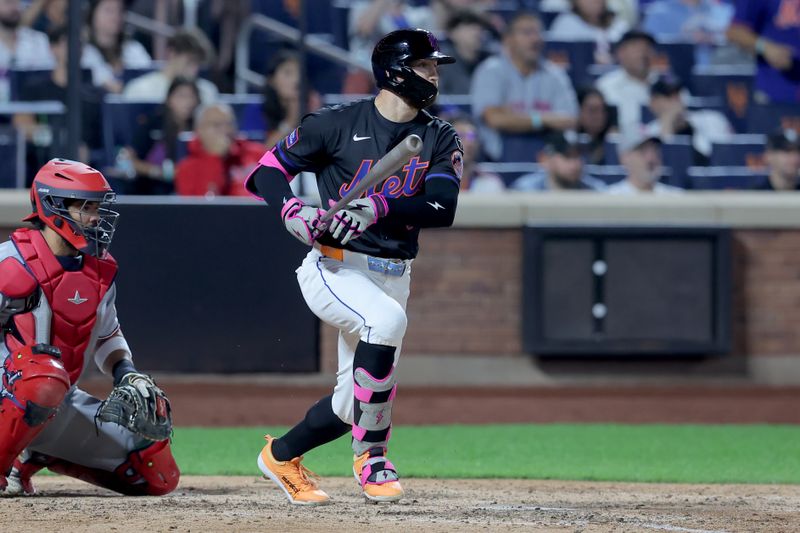 Sep 19, 2025; New York City, New York, USA; New York Mets left fielder Brandon Nimmo (9) follows through on a two run single against the Washington Nationals during the eighth inning at Citi Field. Mandatory Credit: Brad Penner-Imagn Images