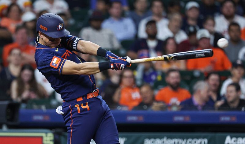 May 1, 2023; Houston, Texas, USA; Houston Astros second baseman Mauricio Dubon (14) hits an RBI double during the seventh inning against the San Francisco Giants at Minute Maid Park. Mandatory Credit: Troy Taormina-USA TODAY Sports