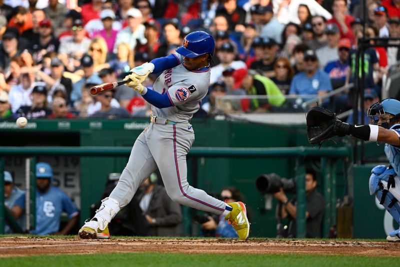 Apr 26, 2025; Washington, District of Columbia, USA; New York Mets shortstop Francisco Lindor (12) singles against the Washington Nationals during the third inning at Nationals Park. Mandatory Credit: Brad Mills-Imagn Images