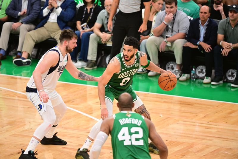 BOSTON, MA - JUNE 17: Jayson Tatum #0 of the Boston Celtics handles the ball while Luka Doncic #77 of the Dallas Mavericks plays defense during the game during Game Five of the 2024 NBA Finals on June 17, 2024 at the TD Garden in Boston, Massachusetts. NOTE TO USER: User expressly acknowledges and agrees that, by downloading and or using this photograph, User is consenting to the terms and conditions of the Getty Images License Agreement. Mandatory Copyright Notice: Copyright 2024 NBAE  (Photo by Adam Hagy/NBAE via Getty Images)