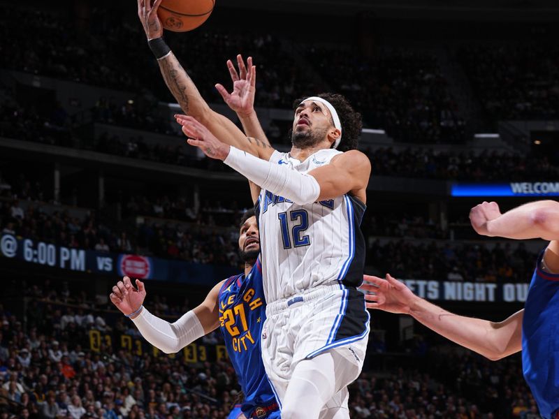 DENVER, CO - JANUARY 5: Trevelin Queen #12 of the Orlando Magic drives to the basket during the game against the Denver Nuggets on January 5, 2024 at the Ball Arena in Denver, Colorado. NOTE TO USER: User expressly acknowledges and agrees that, by downloading and/or using this Photograph, user is consenting to the terms and conditions of the Getty Images License Agreement. Mandatory Copyright Notice: Copyright 2024 NBAE (Photo by Garrett Ellwood/NBAE via Getty Images)