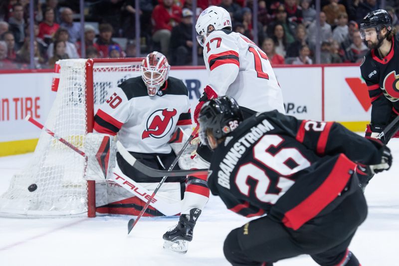 Dec 29, 2023; Ottawa, Ontario, CAN; New Jersey Devils goalie Nico Daws (50) makes a save on a shot from Ottawa Senators defenseman Erik Brannstrom (26) in the first period at the Canadian Tire Centre. Mandatory Credit: Marc DesRosiers-USA TODAY Sports