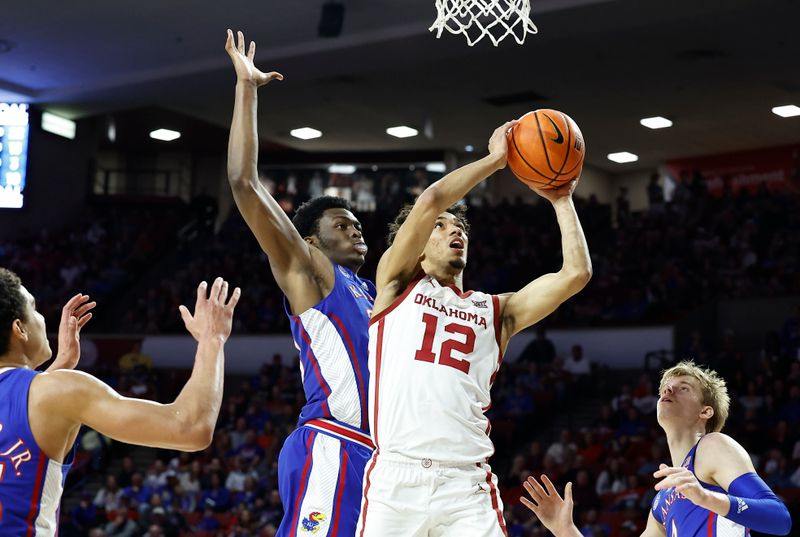 Feb 11, 2023; Norman, Oklahoma, USA; Oklahoma Sooners guard Milos Uzan (12) shoots against the Kansas Jayhawks during the second half at Lloyd Noble Center. Kansas won 78-55. Mandatory Credit: Alonzo Adams-USA TODAY Sports