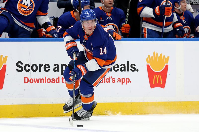 Nov 30, 2024; Elmont, New York, USA; New York Islanders center Bo Horvat (14) skates with the puck against the Buffalo Sabres during the second period at UBS Arena. Mandatory Credit: Brad Penner-Imagn Images