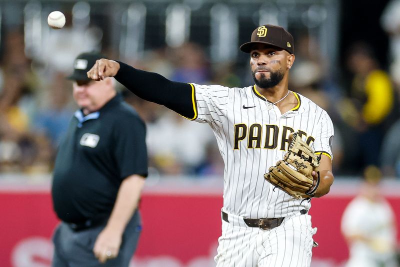Sep 23, 2025; San Diego, California, USA; San Diego Padres shortstop Xander Bogaerts (2) throws to first for an out during the fifth inning against the Milwaukee Brewers at Petco Park. Mandatory Credit: David Frerker-Imagn Images