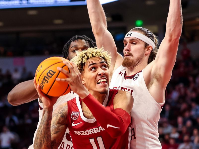 Feb 4, 2023; Columbia, South Carolina, USA; Arkansas Razorbacks forward Jalen Graham (11) looks to shoot over South Carolina Gamecocks forward Hayden Brown (10) in the first half at Colonial Life Arena. Mandatory Credit: Jeff Blake-USA TODAY Sports