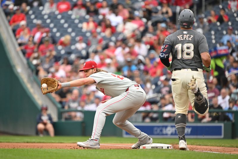 Sep 29, 2024; Washington, District of Columbia, USA; Philadelphia Phillies third baseman Alec Bohm (28) catches the ball for an out in front of Washington Nationals first baseman Juan Yepez (18) during the first inning at Nationals Park. Mandatory Credit: Rafael Suanes-Imagn Images