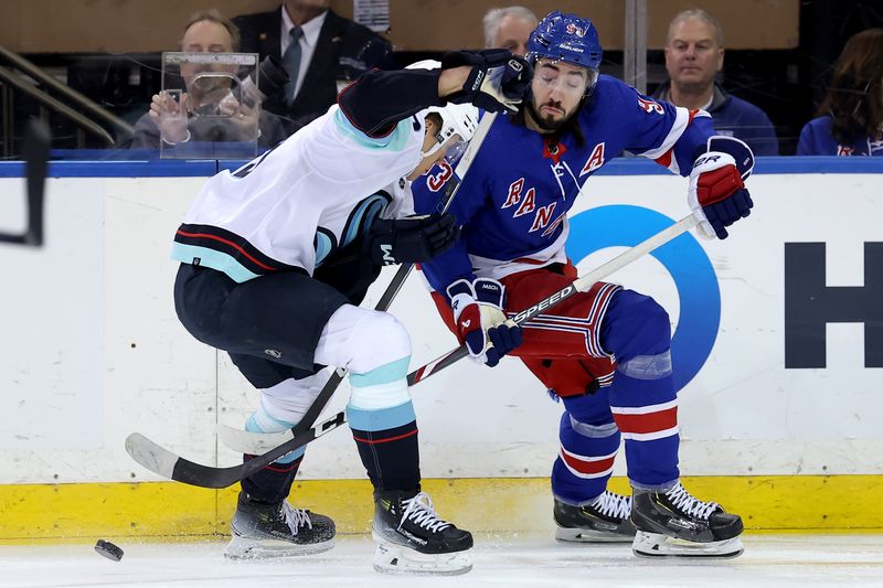 Jan 16, 2024; New York, New York, USA; New York Rangers center Mika Zibanejad (93) fights for the puck against Seattle Kraken defenseman Ryker Evans (39) during the first period at Madison Square Garden. Mandatory Credit: Brad Penner-USA TODAY Sports