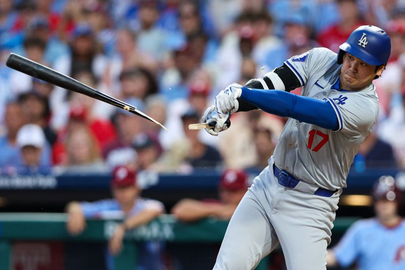 Jul 11, 2024; Philadelphia, Pennsylvania, USA; Los Angeles Dodgers two-way player Shohei Ohtani (17) breaks his bat while hitting into a ground out during the seventh inning against the Philadelphia Phillies at Citizens Bank Park. Mandatory Credit: Bill Streicher-USA TODAY Sports