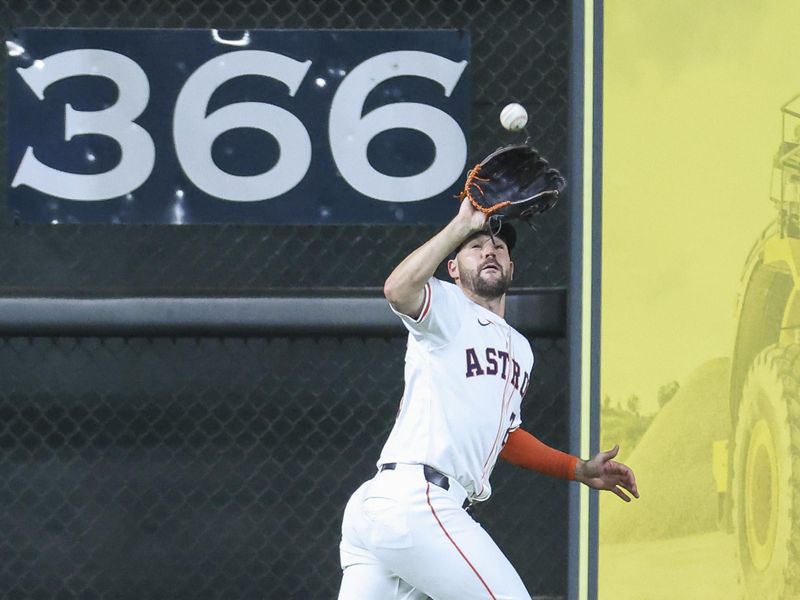 Apr 3, 2024; Houston, Texas, USA; Houston Astros left fielder Chas McCormick (20) catches a fly ball during the third inning against the Toronto Blue Jays at Minute Maid Park. Mandatory Credit: Troy Taormina-USA TODAY Sports