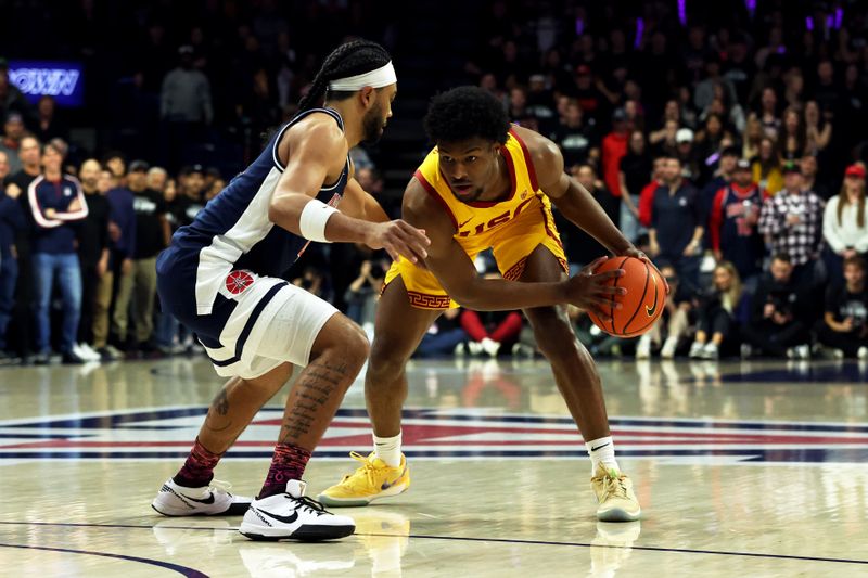 Jan 17, 2024; Tucson, Arizona, USA; USC Trojans guard Bronny James (6) dribbles the ball against Arizona Wildcats guard Kylan Boswell (4) during the first half at McKale Center. Mandatory Credit: Zachary BonDurant-USA TODAY Sports