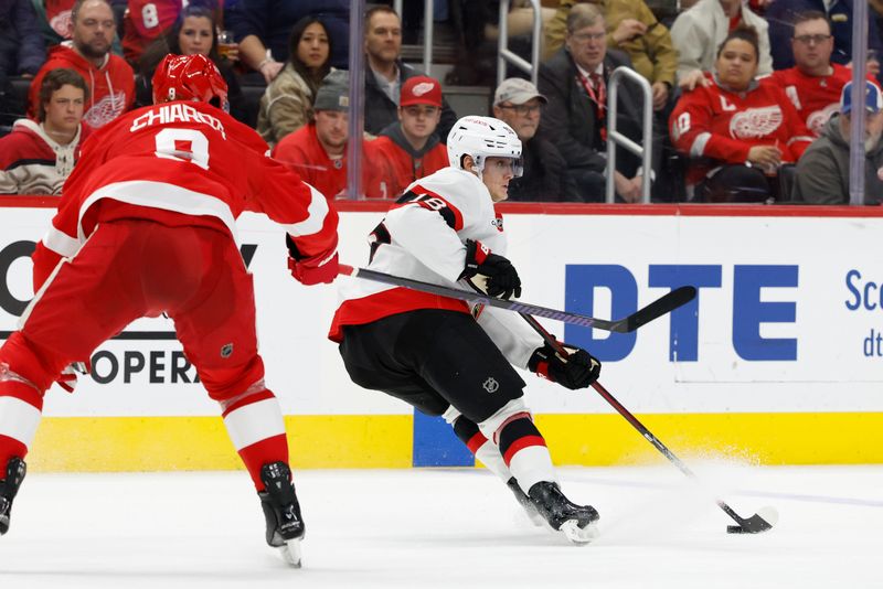 Jan 7, 2025; Detroit, Michigan, USA; Ottawa Senators center Tim Stützle (18) skates with the puck defended by Detroit Red Wings defenseman Ben Chiarot (8) in the third period at Little Caesars Arena. Mandatory Credit: Rick Osentoski-Imagn Images