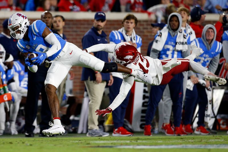 Oct 7, 2023; Oxford, Mississippi, USA; Mississippi Rebels wide receiver Tre Harris (9) catches a pass over Arkansas Razorbacks defensive back Alfahiym Walcott (13) during the first half at Vaught-Hemingway Stadium. Mandatory Credit: Petre Thomas-USA TODAY Sports