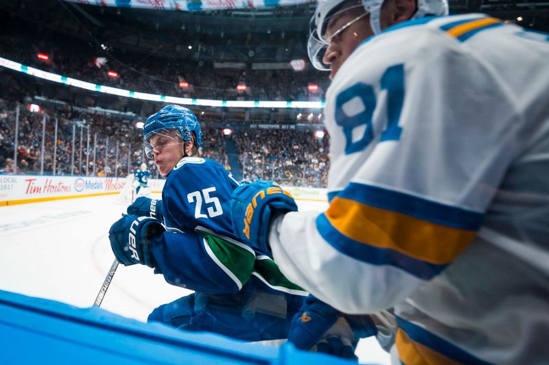 Oct 13, 2025; Vancouver, British Columbia, CAN; Vancouver Canucks defenseman Elias Pettersson (25) checks St. Louis Blues forward Dylan Holloway (81) in the third period at Rogers Arena. Mandatory Credit: Bob Frid-Imagn Images