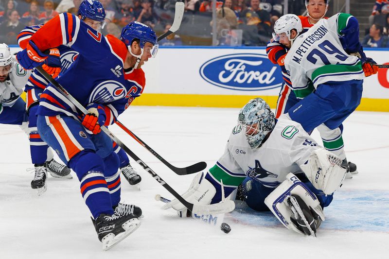 Sep 28, 2025; Edmonton, Alberta, CAN; Vancouver Canucks goaltender Thatcher Demko (35) makes a save on  on Edmonton Oilers forward Connor McDavid (97) during the first period at Rogers Place. Mandatory Credit: Perry Nelson-Imagn Images