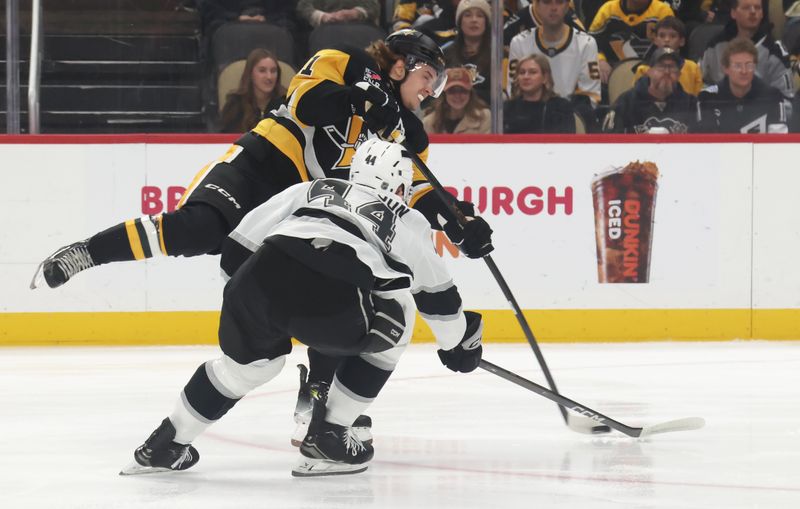 Nov 9, 2025; Pittsburgh, Pennsylvania, USA;  Pittsburgh Penguins right wing Ville Koivunen (41) shoots the puck as Los Angeles Kings defenseman Mikey Anderson (44) defends during the first period at PPG Paints Arena. Mandatory Credit: Charles LeClaire-Imagn Images