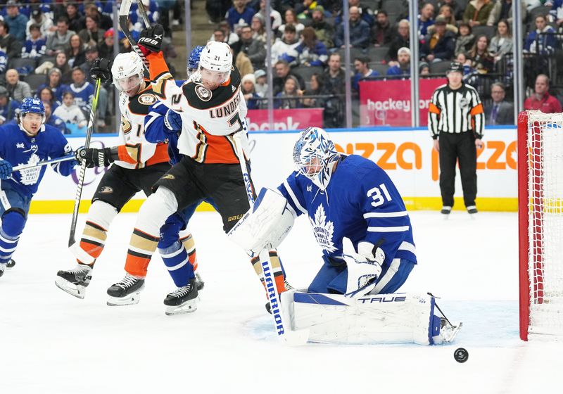 Feb 17, 2024; Toronto, Ontario, CAN; Anaheim Ducks center Isac Lundestrom (21) battles for the puck in front of Toronto Maple Leafs goaltender Martin Jones (31) during the second period at Scotiabank Arena. Mandatory Credit: Nick Turchiaro-USA TODAY Sports