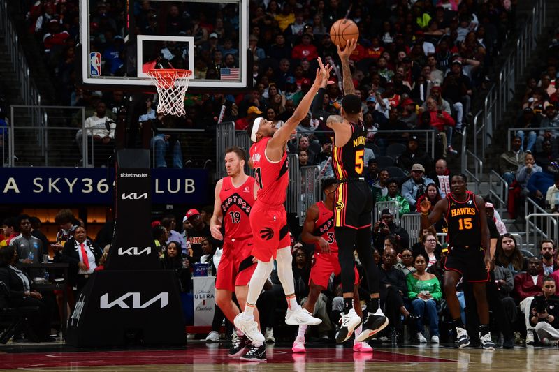 ATLANTA, GA - February 23:  Dejounte Murray #5 of the Atlanta Hawks shoots the ball during the game as Bruce Brown #11 of the Toronto Raptors plays defense on February 23, 2024 at State Farm Arena in Atlanta, Georgia.  NOTE TO USER: User expressly acknowledges and agrees that, by downloading and/or using this Photograph, user is consenting to the terms and conditions of the Getty Images License Agreement. Mandatory Copyright Notice: Copyright 2024 NBAE (Photo by Scott Cunningham/NBAE via Getty Images)