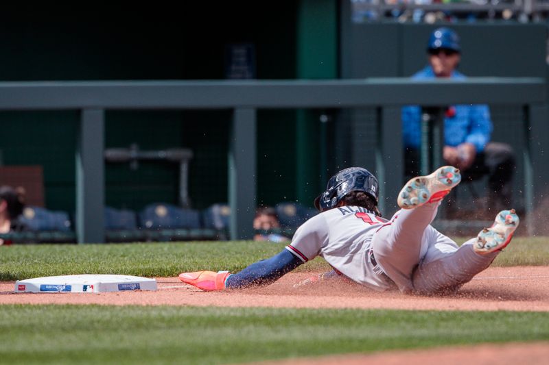 Apr 16, 2023; Kansas City, Missouri, USA; Atlanta Braves right fielder Ronald Acuna Jr. (13) dives into third base during the seventh inning against the Kansas City Royals at Kauffman Stadium. Mandatory Credit: William Purnell-USA TODAY Sports