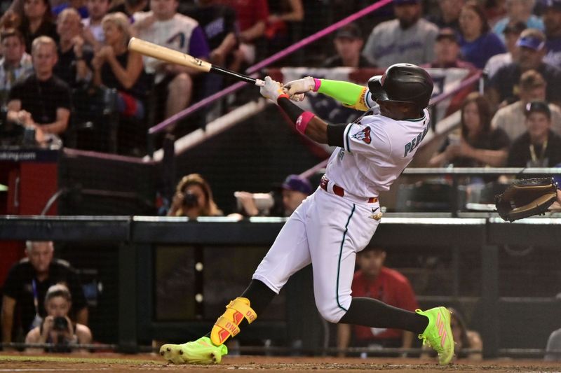 Oct 11, 2023; Phoenix, Arizona, USA; Arizona Diamondbacks shortstop Geraldo Perdomo (2) hits a home run against the Los Angeles Dodgers in the third inning for game three of the NLDS for the 2023 MLB playoffs at Chase Field. Mandatory Credit: Matt Kartozian-USA TODAY Sports