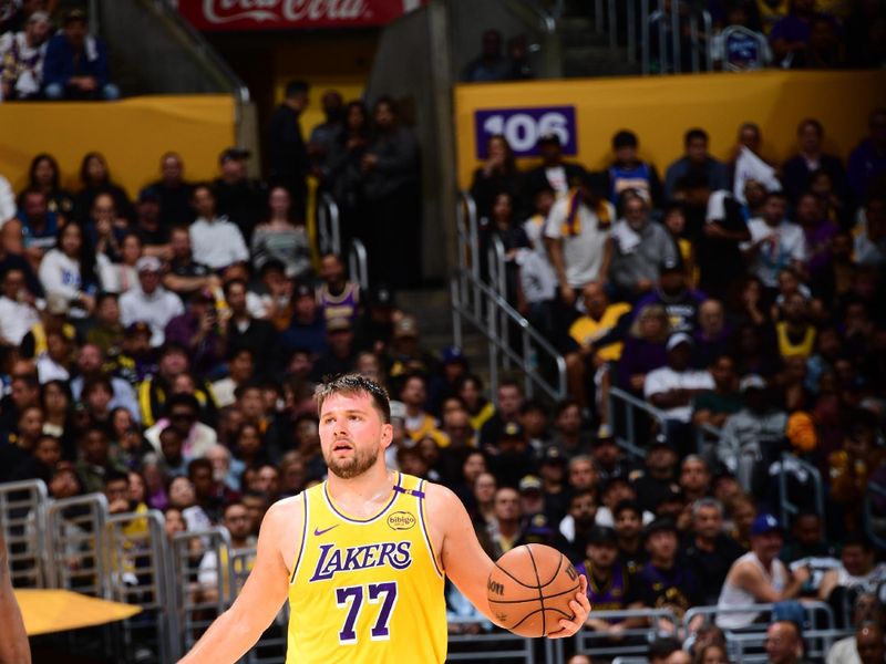 LOS ANGELES, CA - APRIL 22:  Luka Doncic #77 of the Los Angeles Lakers handles the ball during the game against the Minnesota Timberwolves during Round 1 Game 2 of the 2025 NBA Playoffs on April 22, 2025 at Crypto.Com Arena in Los Angeles, California. NOTE TO USER: User expressly acknowledges and agrees that, by downloading and/or using this Photograph, user is consenting to the terms and conditions of the Getty Images License Agreement. Mandatory Copyright Notice: Copyright 2025 NBAE (Photo by Adam Pantozzi/NBAE via Getty Images)