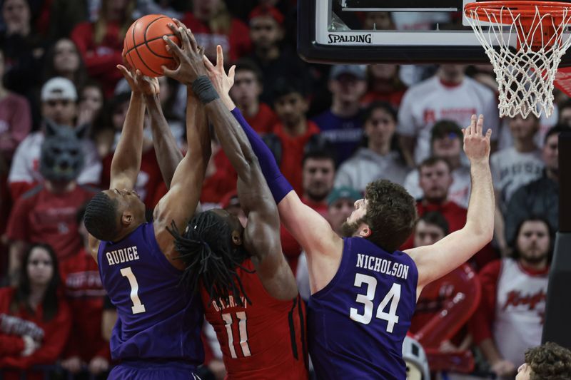 Mar 5, 2023; Piscataway, New Jersey, USA; Northwestern Wildcats center Matthew Nicholson (34) and guard Chase Audige (1) rebound against center Matthew Nicholson (34) during the first half at Jersey Mike's Arena. Mandatory Credit: Vincent Carchietta-USA TODAY Sports