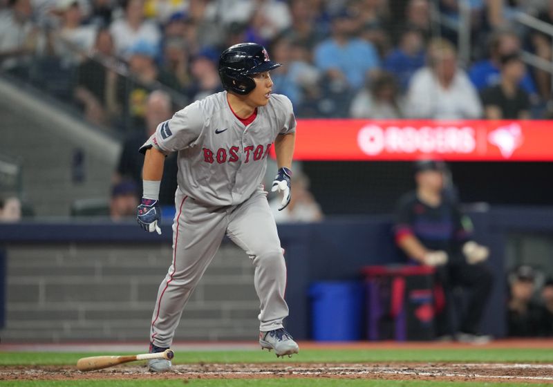 Jun 19, 2024; Toronto, Ontario, CAN; Boston Red Sox designated hitter Masataka Yoshida (7) hits a single against the Toronto Blue Jays during sixth inning at Rogers Centre. Mandatory Credit: Nick Turchiaro-USA TODAY Sports