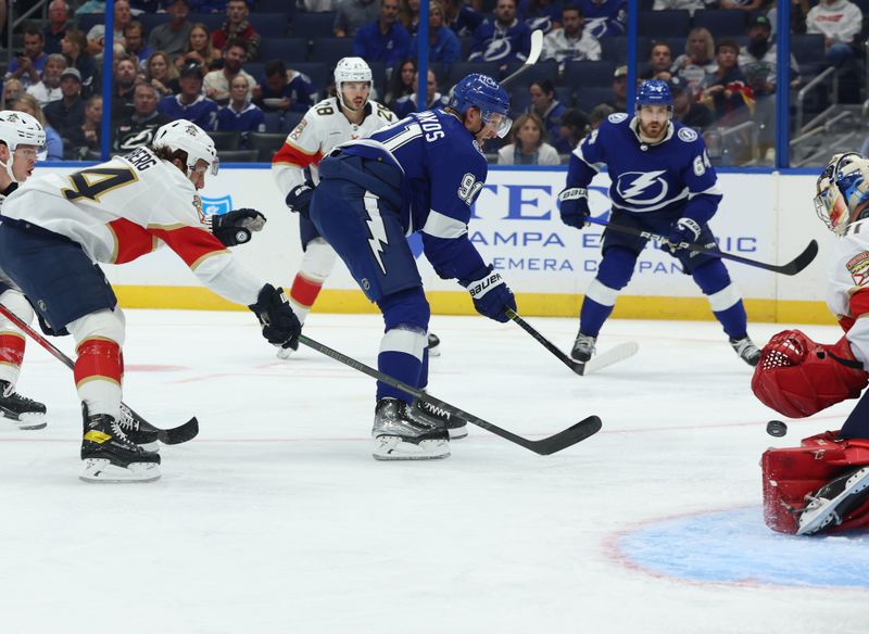 Oct 5, 2023; Tampa, Florida, USA; Tampa Bay Lightning center Steven Stamkos (91) shoots on goal as Florida Panthers goalie Anthony Stolarz (41) defends defends during the second period at Amalie Arena. Mandatory Credit: Kim Klement Neitzel-USA TODAY Sports