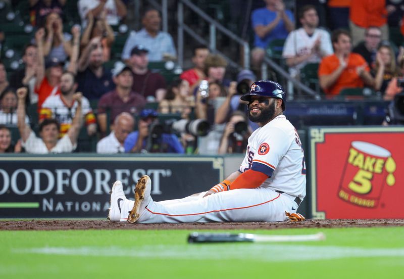 Jul 10, 2024; Houston, Texas, USA; Houston Astros first baseman Jon Singleton (28) smiles after sliding at home plate to score a run during the second inning against the Miami Marlins at Minute Maid Park. Mandatory Credit: Troy Taormina-USA TODAY Sports