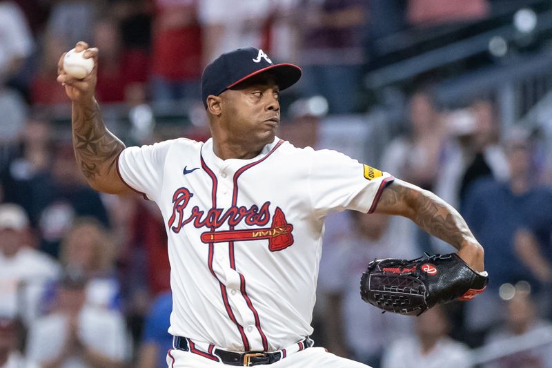 Aug 22, 2024; Cumberland, Georgia, USA; Atlanta Braves pitcher Raisel Iglesias (26) pitches the ball against Philadelphia Phillies during the ninth inning at Truist Park. Mandatory Credit: Jordan Godfree-USA TODAY Sports