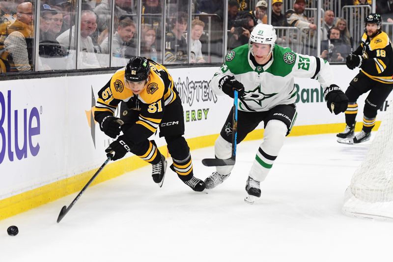 Oct 24, 2024; Boston, Massachusetts, USA;  Boston Bruins center Matthew Poitras (51) and Dallas Stars defenseman Esa Lindell (23) chase after the puck during the third period at TD Garden. Mandatory Credit: Bob DeChiara-Imagn Images