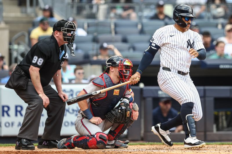 Jun 23, 2024; Bronx, New York, USA;  New York Yankees center fielder Trent Grisham (12) hits a single in the sixth inning against the Atlanta Braves at Yankee Stadium. Mandatory Credit: Wendell Cruz-USA TODAY Sports