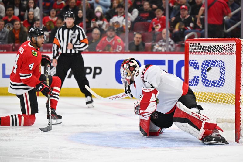 Mar 6, 2023; Chicago, Illinois, USA;  Chicago Blackhawks defenseman Seth Jones (4) scores a goal on Ottawa Senators goaltender Mads Sogaard (40) in the second period at United Center. Mandatory Credit: Jamie Sabau-USA TODAY Sports