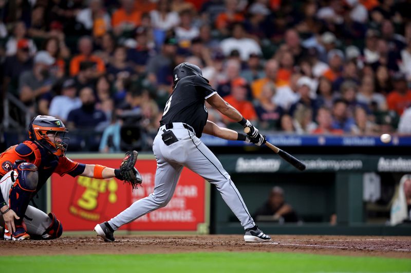 Aug 16, 2024; Houston, Texas, USA; Chicago White Sox shortstop Nicky Lopez (8) hits a single to left field against the Houston Astros during the third inning at Minute Maid Park. Mandatory Credit: Erik Williams-USA TODAY Sports