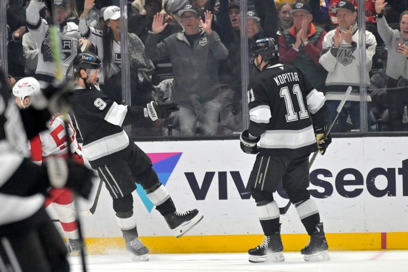 Nov 16, 2024; Los Angeles, California, USA; Los Angeles Kings right wing Adrian Kempe (9) celebrates an empty net goal on a pass from center Anze Kopitar (11) in the third period against the Detroit Red Wings at Crypto.com Arena. Mandatory Credit: Jayne Kamin-Oncea-Imagn Images