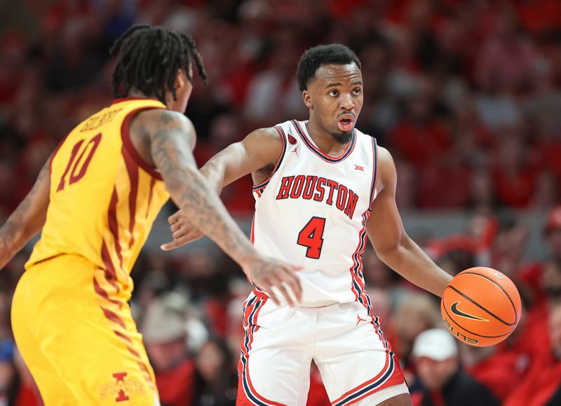 Feb 19, 2024; Houston, Texas, USA; Houston Cougars guard L.J. Cryer (4) controls the ball as Iowa State Cyclones guard Keshon Gilbert (10) defends during the game at Fertitta Center. Mandatory Credit: Troy Taormina-USA TODAY Sports