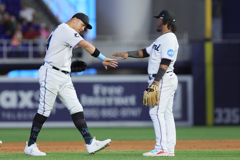 Jul 30, 2023; Miami, Florida, USA; Miami Marlins right fielder Avisail Garcia (24) celebrates with third baseman Jean Segura (9) after defeating the Detroit Tigers at loanDepot Park. Mandatory Credit: Sam Navarro-USA TODAY Sports