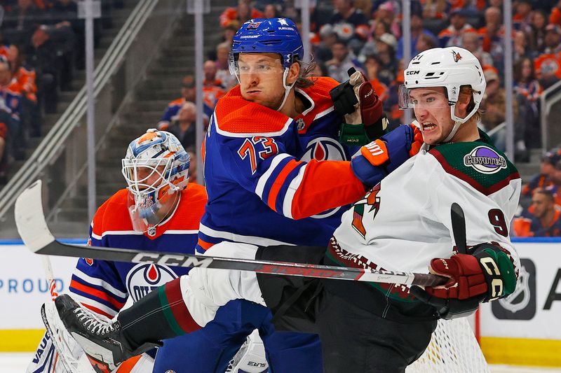 Apr 12, 2024; Edmonton, Alberta, CAN; Edmonton Oilers defensemen Vincent Desharnais (73) and Arizona Coyotes forward Josh Doan (91) battles for position  during the second period at Rogers Place. Mandatory Credit: Perry Nelson-USA TODAY Sports