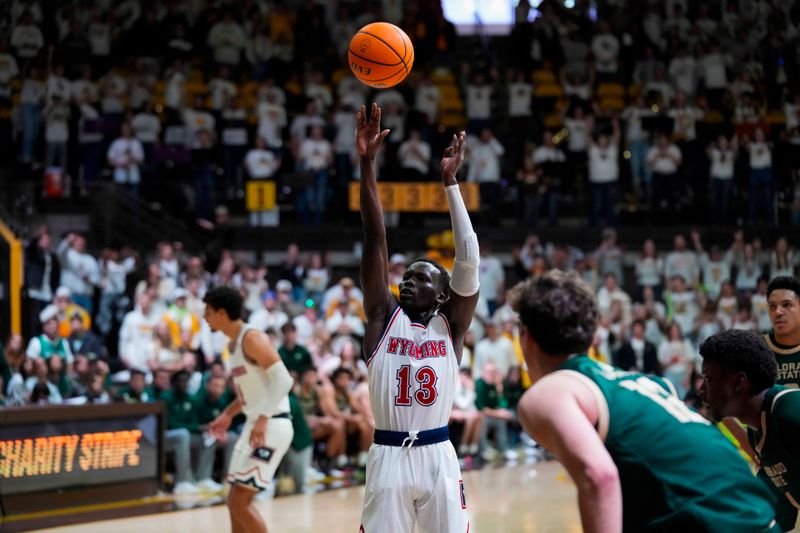 Jan 27, 2024; Laramie, Wyoming, USA; Wyoming Cowboys guard Akuel Kot (13) makes his free throw against the Colorado State Rams during overtime at Arena-Auditorium. Mandatory Credit: Troy Babbitt-USA TODAY Sports