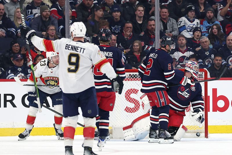 Jan 22, 2026; Winnipeg, Manitoba, CAN; Florida Panthers center Sam Bennett (9) celebrates his goal on Winnipeg Jets goaltender Connor Hellebuyck (37) in the second period at Canada Life Centre. Mandatory Credit: James Carey Lauder-Imagn Images