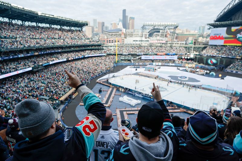 Jan 1, 2024; Seattle, Washington, USA; Seattle Kraken fans cheer following a goal against the Vegas Golden Knights during the first period in the 2024 Winter Classic ice hockey game at T-Mobile Park. Mandatory Credit: Joe Nicholson-USA TODAY Sports