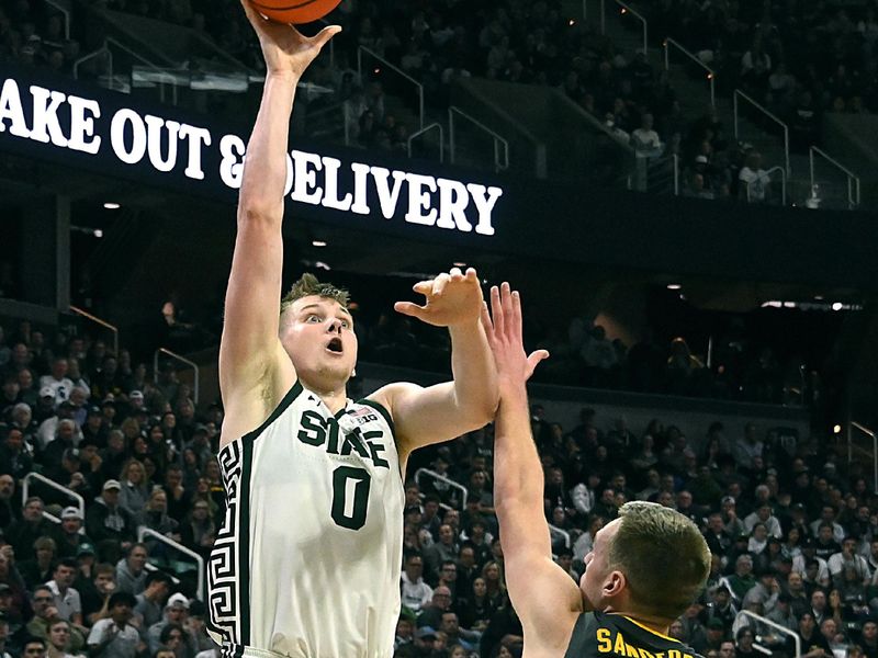 Feb 20, 2024; East Lansing, Michigan, USA;  Michigan State Spartans forward Jaxon Kohler (0) shoots over Iowa Hawkeyes forward Payton Sandfort (20) during the second half at Jack Breslin Student Events Center. Mandatory Credit: Dale Young-USA TODAY Sports
