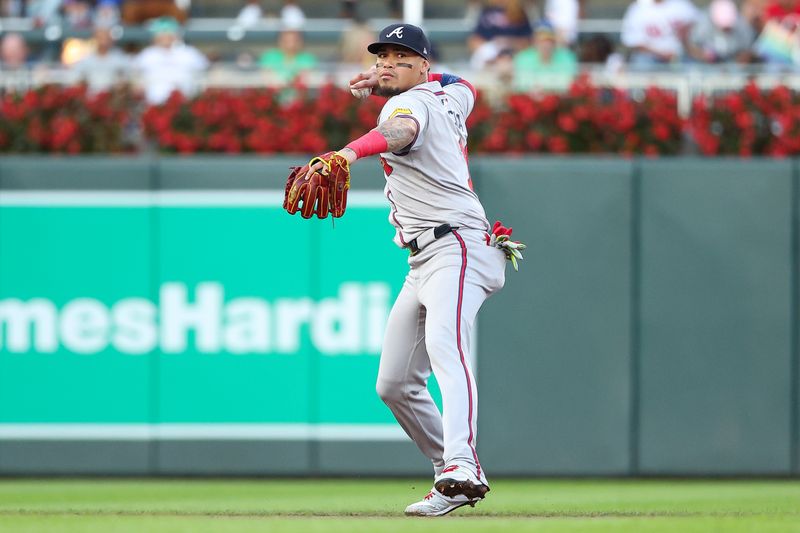 Aug 28, 2024; Minneapolis, Minnesota, USA; Atlanta Braves shortstop Orlando Arcia (11) throws the ball to first base to get out Minnesota Twins shortstop Willi Castro (50) during the second inning at Target Field. Mandatory Credit: Matt Krohn-USA TODAY Sports