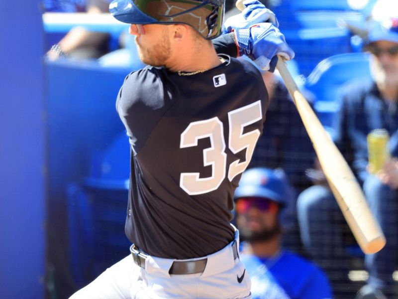 Feb 24, 2026; Dunedin, Florida, USA;  New York Yankees left fielder Cody Bellinger (35) hits a RBI single first inning against the Toronto Blue Jays at TD Ballpark. Mandatory Credit: Kim Klement Neitzel-Imagn Images