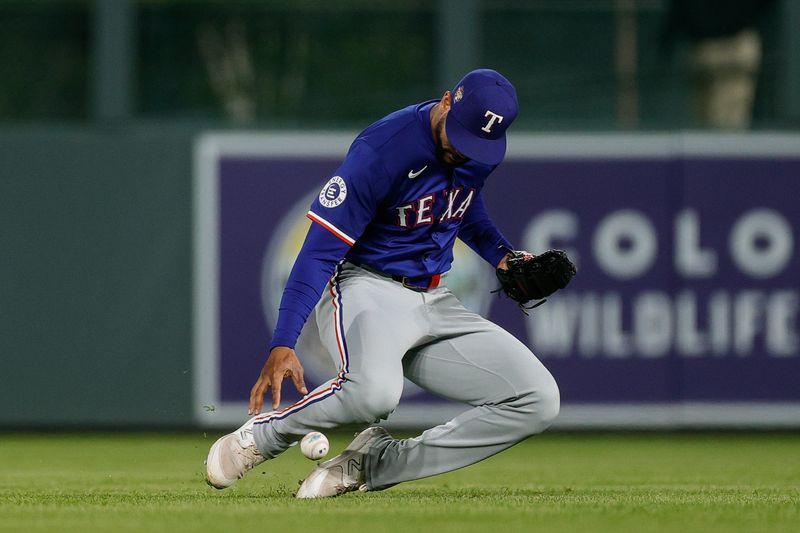 May 10, 2024; Denver, Colorado, USA; Texas Rangers center fielder Leody Taveras (3) is unable to make a catch in the seventh inning against the Colorado Rockies at Coors Field. Mandatory Credit: Isaiah J. Downing-USA TODAY Sports