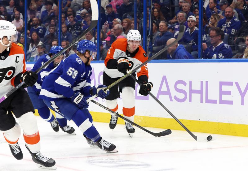 Nov 24, 2025; Tampa, Florida, USA; Philadelphia Flyers defenseman Egor Zamula (5) passes the puck as Tampa Bay Lightning center Jake Guentzel (59) defends during the third period at Benchmark International Arena. Mandatory Credit: Kim Klement Neitzel-Imagn Images