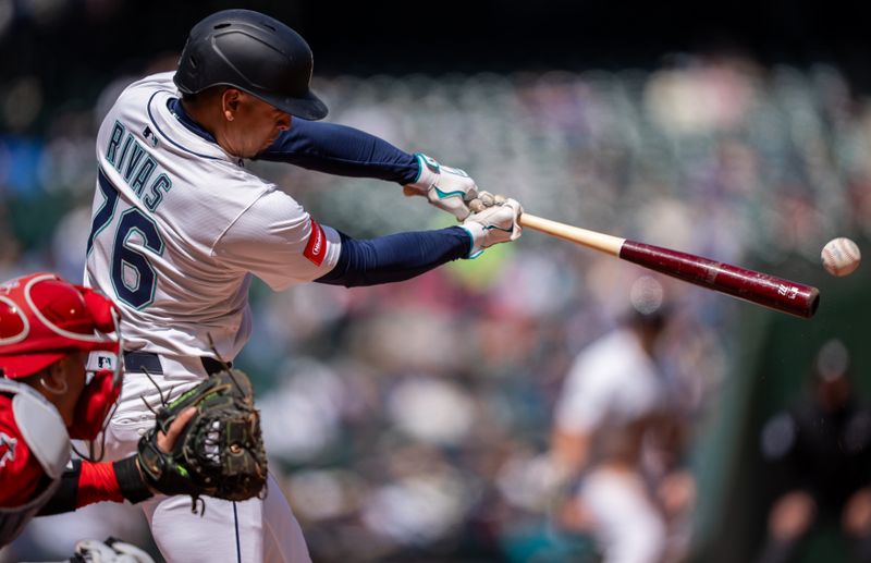 Apr 30, 2025; Seattle, Washington, USA;  Seattle Mariners second baseman Leo Rivas (76) hits a RBI-single during the second inning against the Los Angeles Angels at T-Mobile Park. Mandatory Credit: Stephen Brashear-Imagn Images
