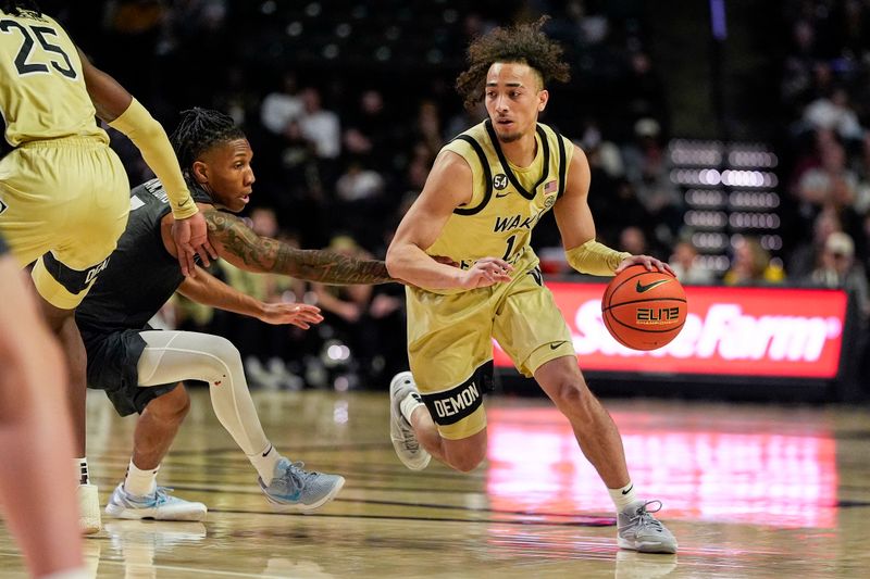 Jan 3, 2026; Winston-Salem, North Carolina, USA; Wake Forest Demon Deacons guard Nate Calmese (1) handles the ball defended by Virginia Tech Hokies guard Ben Hammond (3) during the first half at Lawrence Joel Veterans Memorial Coliseum. Mandatory Credit: Jim Dedmon-Imagn Images